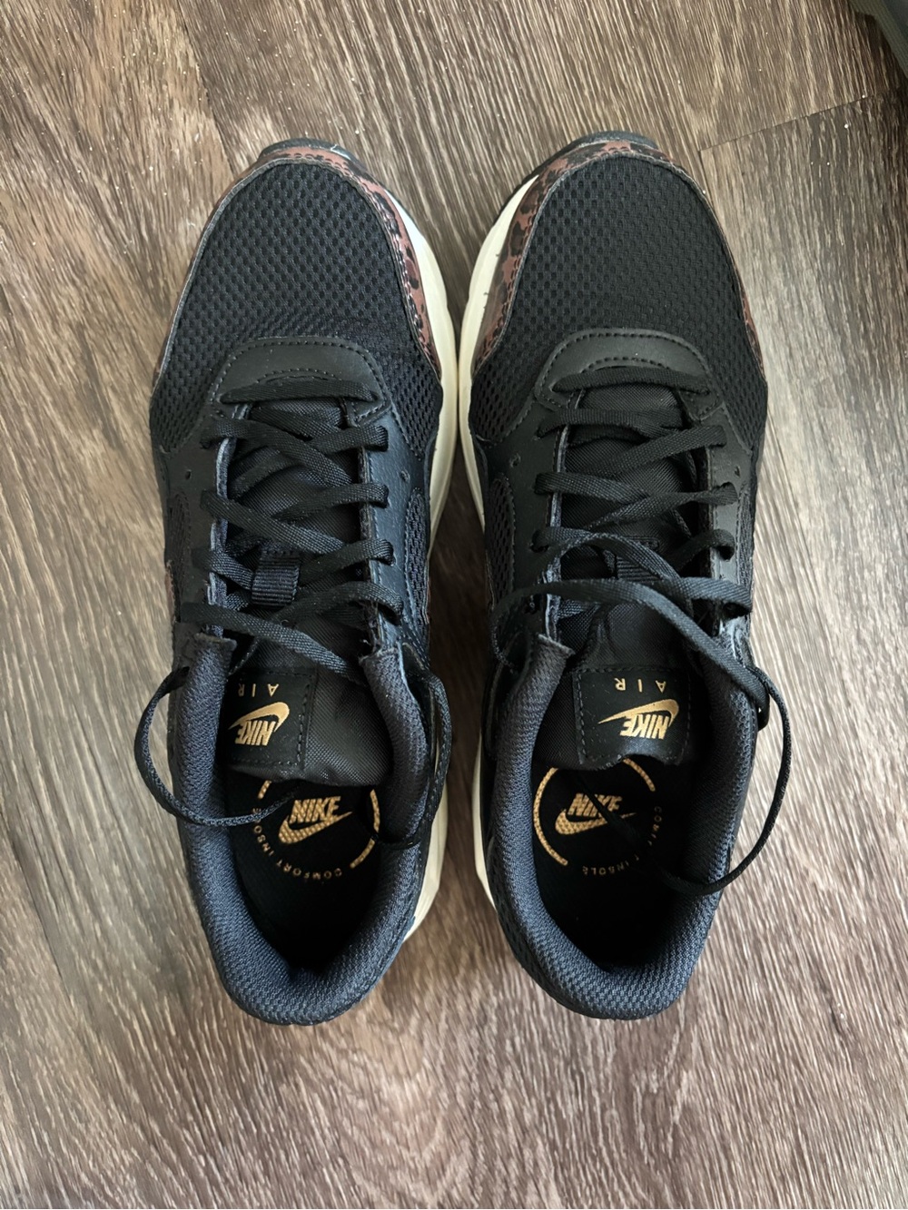 Nike Women’s Black Sneakers with Metallic Gold Accents